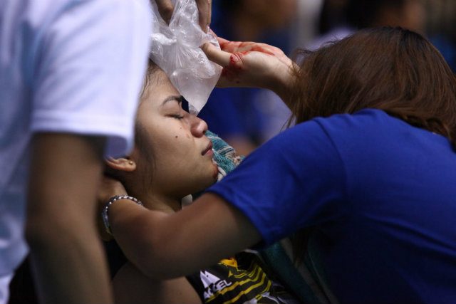 Mela Tunay being iced on the bench after a collision with teammate Pam Lastimosa left her bleeding. She was reportedly brought to the hospital as a precautionary measure. Photo by Josh Albelda/Rappler 
