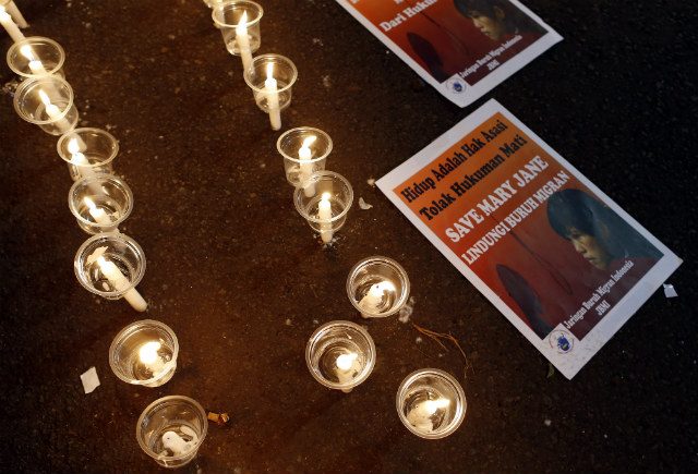 #SAVEMARYJANE. Posters with pictures of Mary Jane Veloso are seen next to candles during a vigil outside the presidential palace in Jakarta, Indonesia on April 26, 2015, to support Veloso, a Filipino maid who is facing execution. Photo by Mast Irham/EPA    