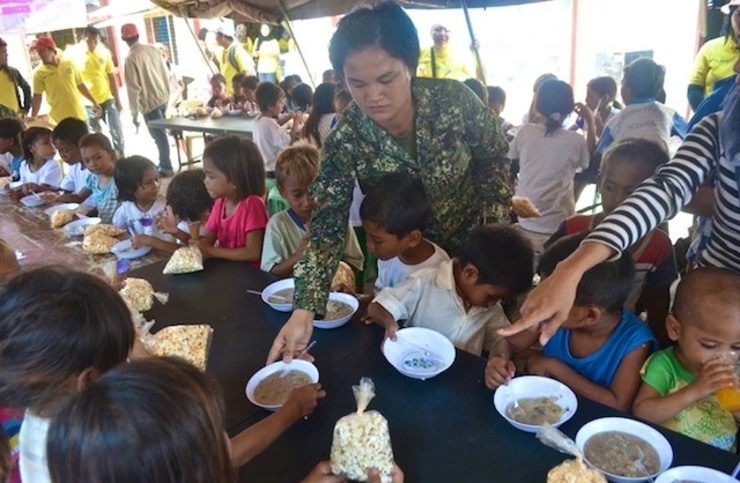 EATING TIME. Badjao children dine on food prepared by the 3rd Marine Battalion
