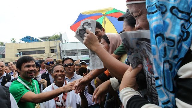 PRESS THE FLESH: Vice President Jejomar Binay and Sarangani Representative Emmanuel Pacquiao engage residents of General Santos. Photo from the OVP