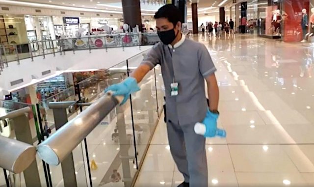 PRECAUTIONARY MEASURE. An employee of Robinsons Malls sanitizes the railing as a preventive measure against the spread of the novel coronavirus. Screenshot from Robinsons Malls video 