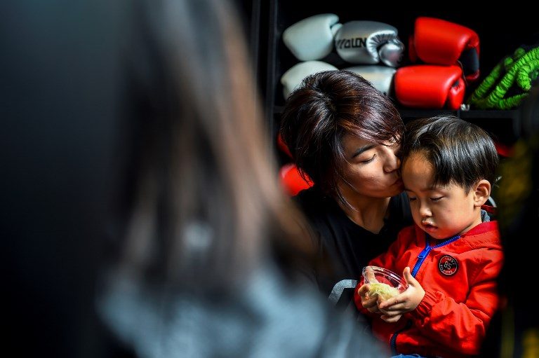 PEANUT. This photo taken on November 7, 2017 shows MMA (mixed martial arts) fighter Miao Jie with her son Li Muyuan, whom she calls Peanut, during a break in a training session in Shanghai. Photo by Chandan Khanna/AFP 