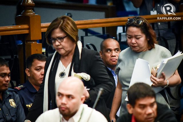 NO REGRETS. Senator Leila de Lima is seen in this photo walking past her former bodyguard and boyfriend Ronnie Dayan (lower right) at a Senate hearing. File photo 