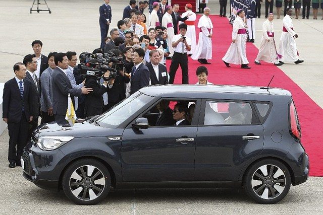 BIG GESTURE. Pope Francis gets into a tiny Kia Soul car, fascinating South Koreans with his humble choice of wheels. File photo by Ahn Young-joon/Pool/AFP  