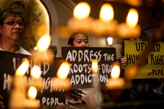 CONDEMNING KILLINGS. Human rights advocates hold placards condemning extrajudicial killings during a Mass at the Redemptorist Church in Manila on August 10, 2016. Photo by Noel Celis/AFP  