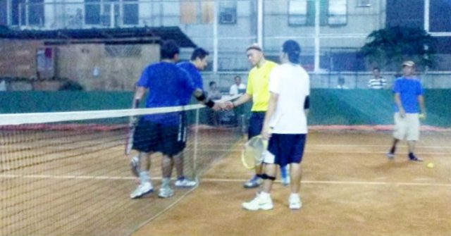 Bicol priests, Father Jerry Pascual and Arnel Haber (in blue shirts), shake the hands of Tagum priests Father Julius Cesar Anas (in yellow shirt) and Noel Gastones after winning their doubles finals match. Photo by Marsante G. Alison 