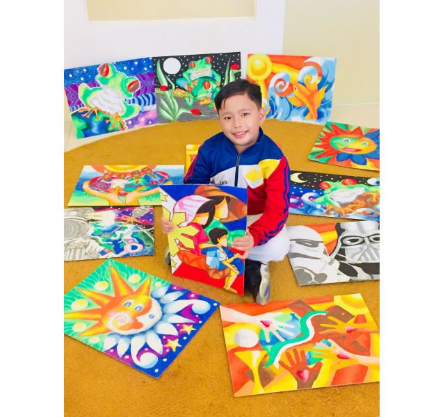LITTLE PICASSO. Worth's love for the Philippines manifests in his art. Here, he holds up his favorite painting called 'La Familia'. 'It’s a Filipino family and it represents the Filipino as one,' he says.  Photo courtesy of Wendy Lodriga   