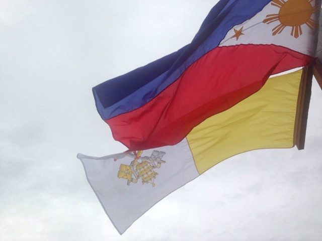 READY. Both the Philippine and Vatican flags are raised at the Tacloban airport open grounds in the days leading up to Pope Francis’ visit to the Typhoon Yolanda-hit province. Photo by Renz Bulseco