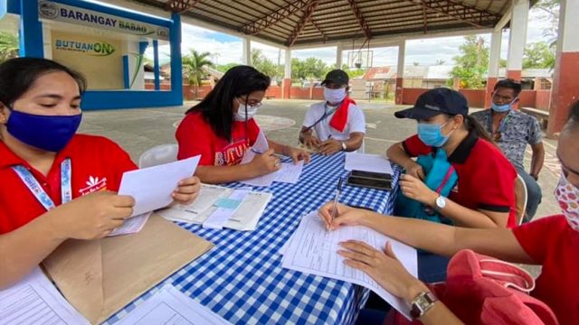 MONITORING. The DSWD Field Office Caraga reviews subsidy cards of beneficiaries in Butuan City, Agusan del Norte. Photo from DSWD Caraga website 