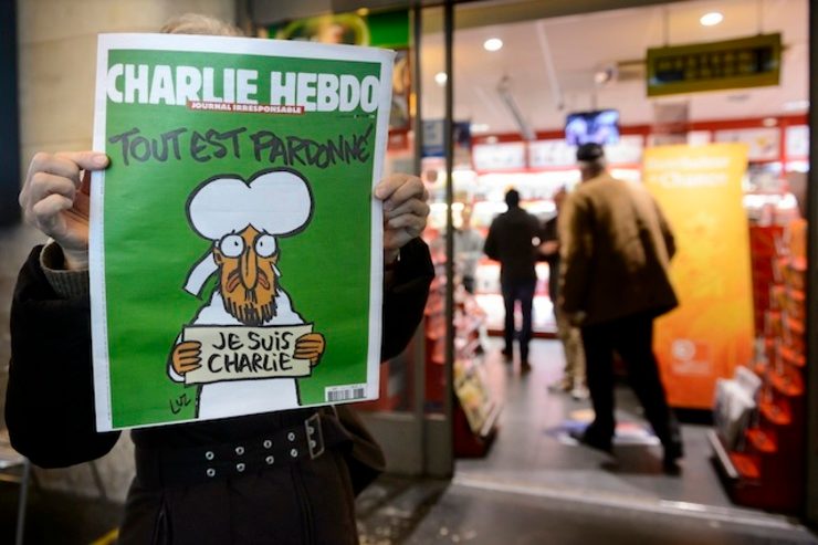 SOLD OUT. A person shows the front page of French satirical magazine Charlie Hebdo in front of a news stand in Lausanne, Switzerland, early 15, January 2015. Photo by Laurent Gillieron/EPA