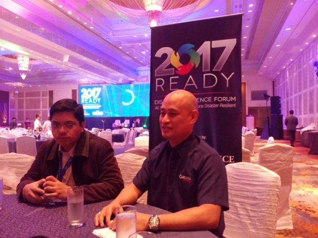 PROTECTED FROM RISK. Jeffrey Perez of Phivolcs and Jonathan Batangan of Cebuana Lhuillier Insurance Solutions discuss how to improve individual and community resiliency. Photo by Lou Gepuela/Rappler  