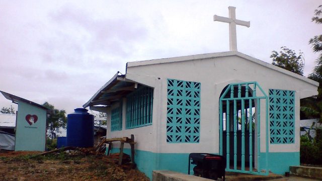 RECOVERING. The rebuilt Chapel, ready for the fiesta celebration and for catechism, literacy and numeracy classes, with the water catchment and community CR on the background. All photos by Rodel Rojo 