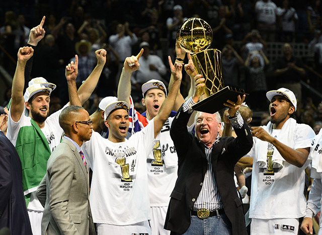 CHAMPIONS. San Antonio Spurs team owner Peter Holt hoists up the Larry O'Brien trophy as he celebrates with the team. Photo by Larry W Smith/EPA