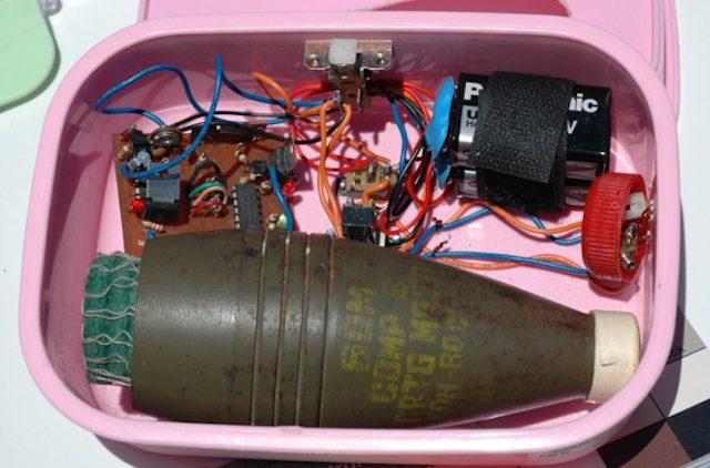 'IRAQI DEVICE.' A type of improvised explosive device hidden in a lunchbox. A layer of food conceals it.