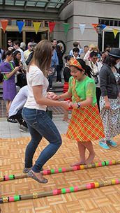 An open house visitor tries tinikling. Photo from Philippine Embassy Washington DC Facebook page