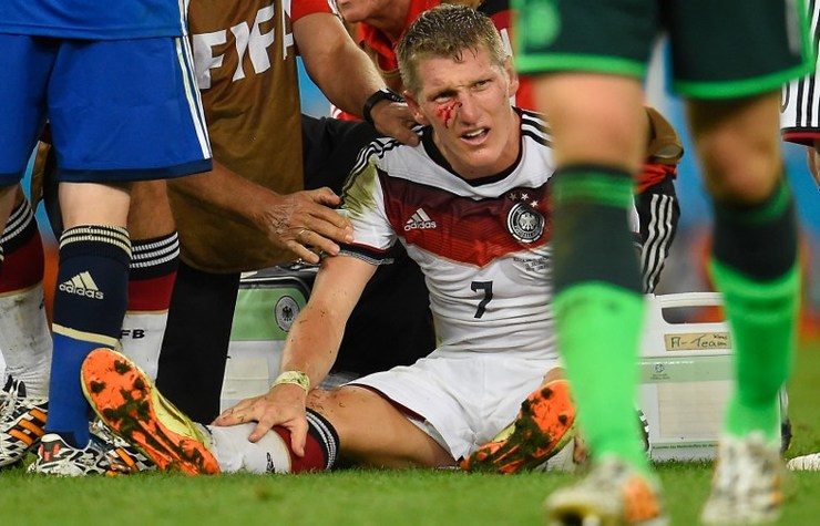Germany's midfielder Bastian Schweinsteiger bleeds after clashing with Argentina's forward Sergio Aguero. Photo by Odd Andersen/AFP