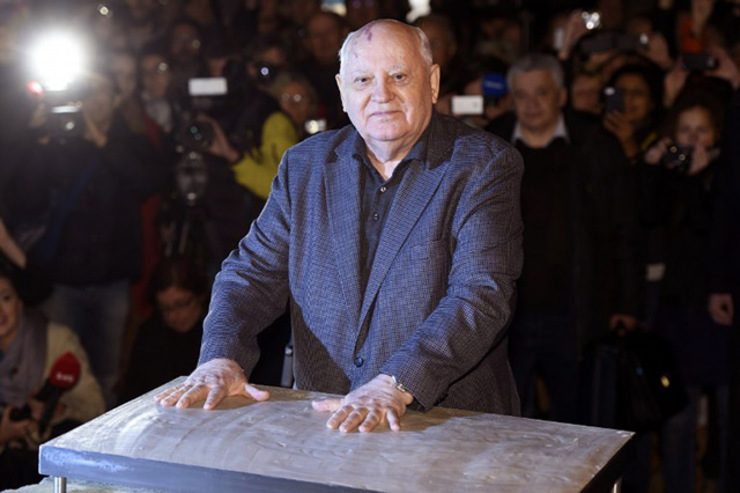 GORBACHEV. The last ruling President of the Soviet Union Mikhail Gorbachev leaves his handprints in plaster cast bolted onto an original Wall piece from former Checkpoint Charlie border crossing on November 7, 2014 in Berlin at event organised by Cinema for Peace. Odd Andersen/AFP
