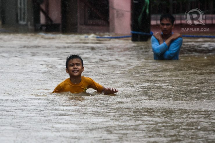 CRISIS CULTURE. During tropical storm Mario, a young boy wades through a flooded street in Marikina. Photo by Manman Dejeto/Rappler