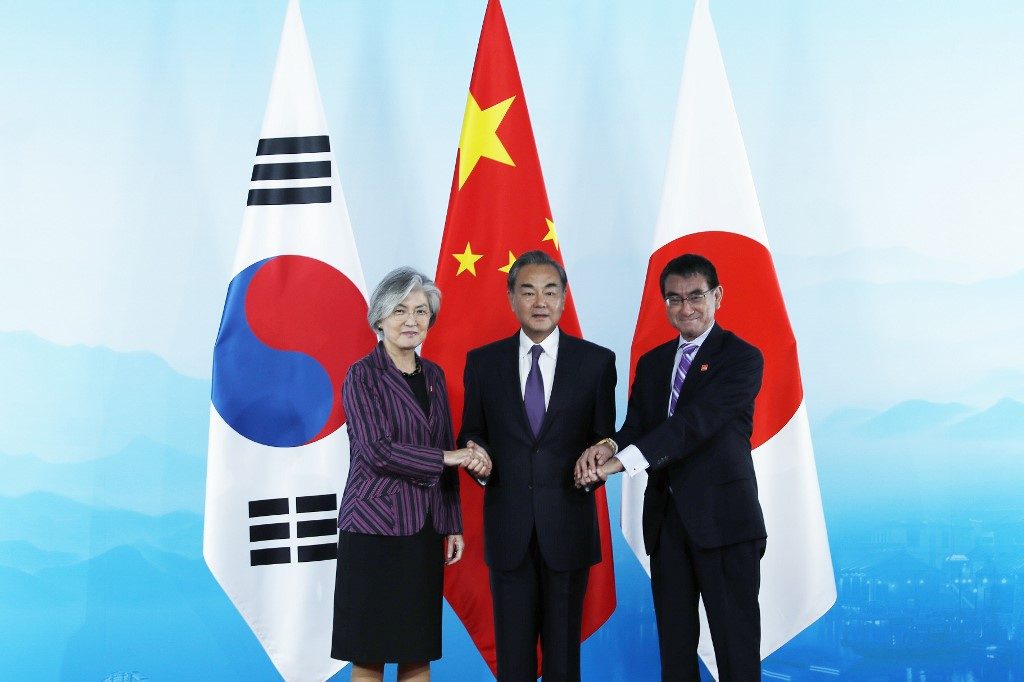 China hosts Japan, South Korea in show of regional unity