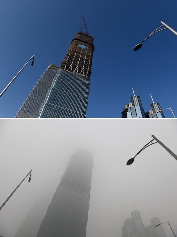 CHOKING SMOG. This combination image of two photographs taken on December 3, 2015 (top) and two days earlier on December 1 (bottom) shows a skyscraper under clear skies and in heavy pollution, as seen in the central business district in Beijing. AFP Photo  