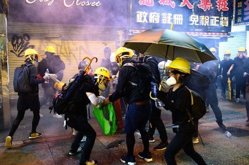 Hong Kong police fire tear gas at protesters in tourist district
