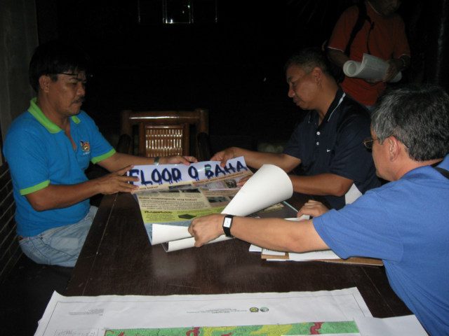 INFORMATION CAMPAIGN. An MGB hazard mapping team confers during one of their information and education campaigns for landslide and flood hazard maps. Photo from MGB  