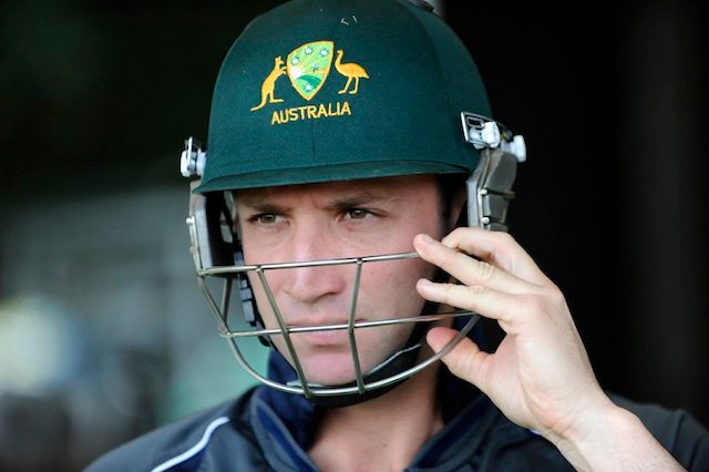 A file picture dated 01 May 2013 shows Australian cricketer Phil Hughes putting his helmet on after National Selector John Inverarity announced Australia's squad for the ICC Champions Trophy in Brisbane, Australia. Dan Peled/EPA