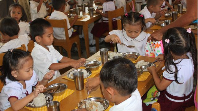MEAL TIME. Preschoolers enjoy their nutritious lunch provided by DSWD's Supplementary Feeding Program. Photo from DSWD