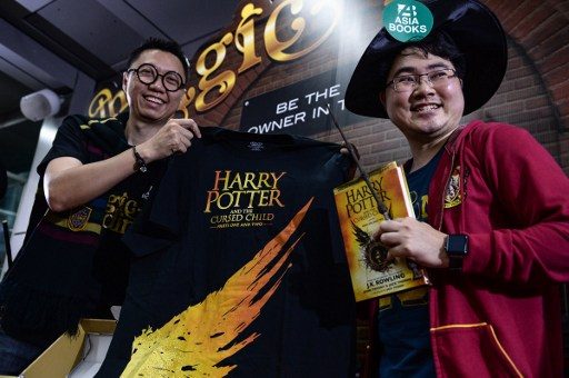 FOREVER FAN. A Harry Potter fan receives the first of the new Harry Potter script book to be launched in Thailand outside Asia Books in Bangkok on July 31, 2016. Photo by Lillian Suwanrumpha/AFP  