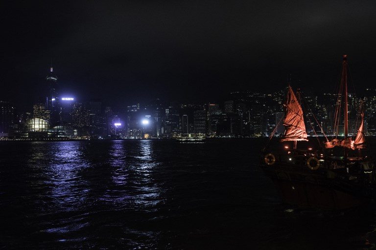 HONG KONG. A traditional Chinese junk sails in Victoria Harbour in front of the skyline after the building lights were switched off for the Earth Hour environmental campaign in Hong Kong on March 24, 2018. Photo by Philip Fong/AFP 