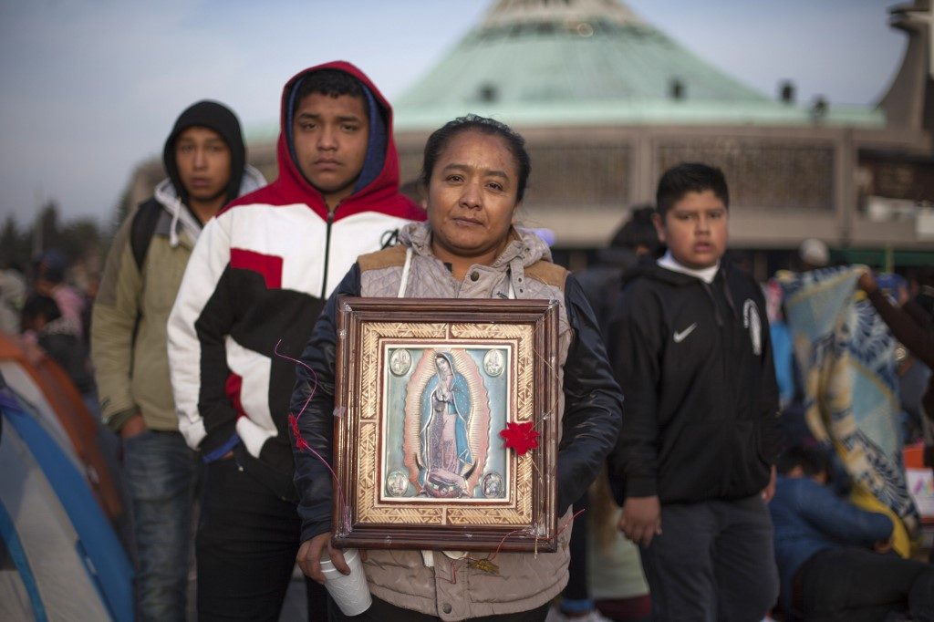 FERVENT. Pilgrims pose with an image of the Virgin of Guadalupe during the annual celebrations at the Basilica of Guadalupe in Mexico City, on December 12, 2019. Photo by Claudio Cruz/AFP  