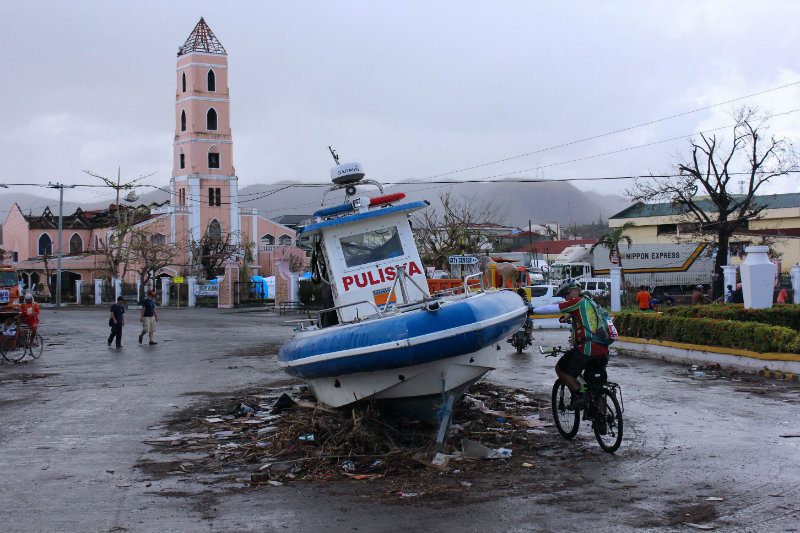 DEBRIS EVERYWHERE. Parts of houses, cars, and even boats litter the streets in the aftermath of Yolanda  