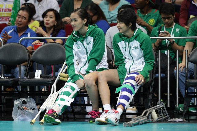 Injured Lady Spikers Camille Cruz and Ara Galang watch from the sidelines. Photo by Josh Albelda 