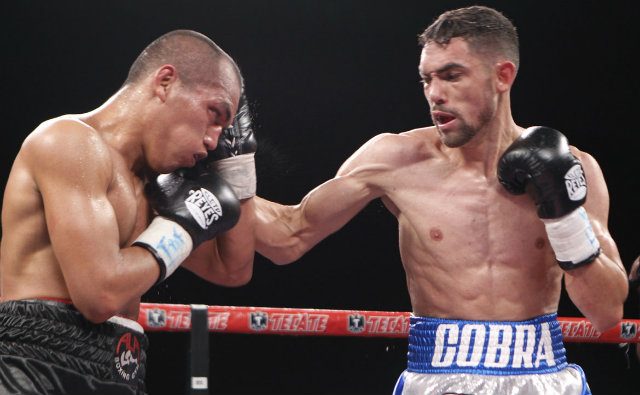 Javier Mendoza lands a southpaw right hook against Melindo. Photo from Zanfer Promotions 
