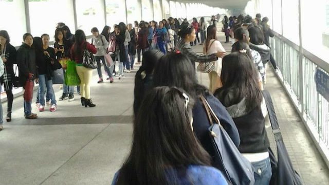 LONG LINES. OFWs in Hong Kong line up for hours to obtain their Overseas Employment Certificates. Photo by Daisy CL Mandap/The Sun-HK 