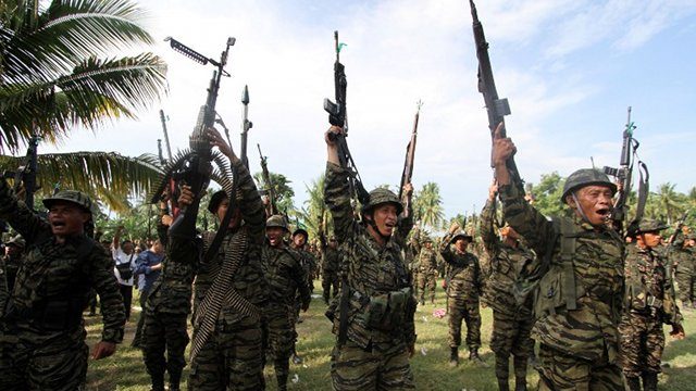 DECOMMISSIONING. This photo taken on Oct 15, 2012 shows members of the MILF shouting 'Allahu Akbar' (God is Great) during a celebration inside camp Darapanan in Sultan Kudarat town in Mindanao, to coincide with the signing of the Framework Agreement. File photo by Karlos Manlupig/AFP  