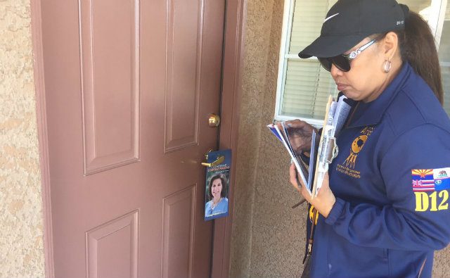 Vivian Rudolph, a Filipina-American volunteering for the Democratic Party, leaves a door hanger which urges support for Nevada senatorial candidate Catherine Cortez Masto. Photo by Ryan Songalia/Rappler  