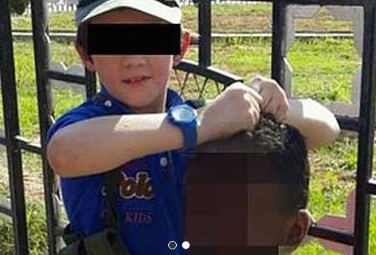 SHOCKING. This photo posted on Twitter shows a child, reported by the newspaper The Australian as the son of Australian-born Islamic State (IS) fighter Khaled Sharrouf, holding a severed head. Image from Twitter, via The Australian