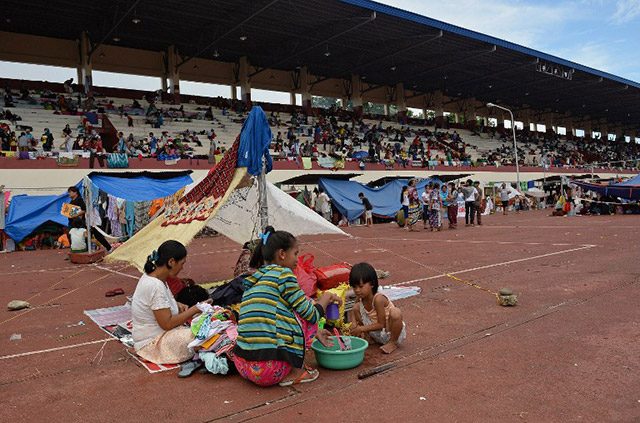 AWAY FROM HOME. Residents living along the coast near the area of a stand-off between the Philippine military and Muslim gunmen take shelter at a sports complex in Zamboanga on September 11, 2013. File photo by Ted Aljibe/AFP   
