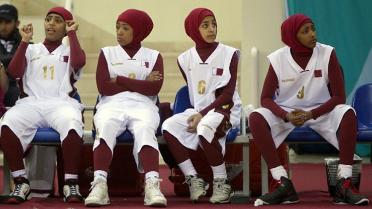 Qatari players wearing Islamic headscarves especially designed for women sit on the bench during their 2011 Arab Games basketball match against Lebanon in 2011. File photo by Marwan Naamani/AFP