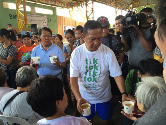 FROM THE VP'S HANDS. Binay handing out porridge among senior citizens in Caloocan City. 
