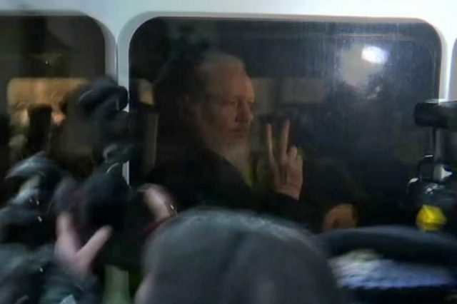 UK minister signs U.S. bid to extradite Assange
