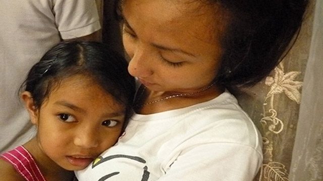 COMFORTING ARMS. Neth's youngest sibling finds comfort in her embrace with the absence of their mother. Photo by Ana P. Santos 