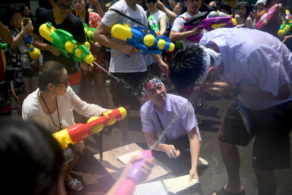 Thai new year splashes in with water fights, raves