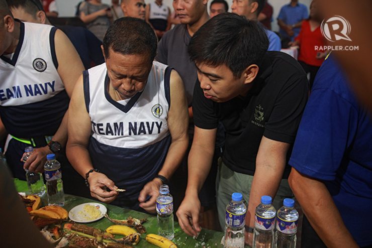 FATHER, SON. The Binay patriarch is joined by son Makati Mayor Junjun Binay in a ‘boodle fight’ at the Navy headquarters on November 11, 2014. Both face plunder raps for an allegedly overpriced Makati building. Photo by Franz Lopez/Rappler