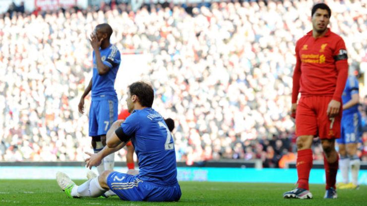 Chelsea's Branislav Ivanovic (L) sits on the floor after being bitten by Liverpool's Luis Suarez (R) during a Premier League game in April of 2013. Photo by Peter Powell/EPA