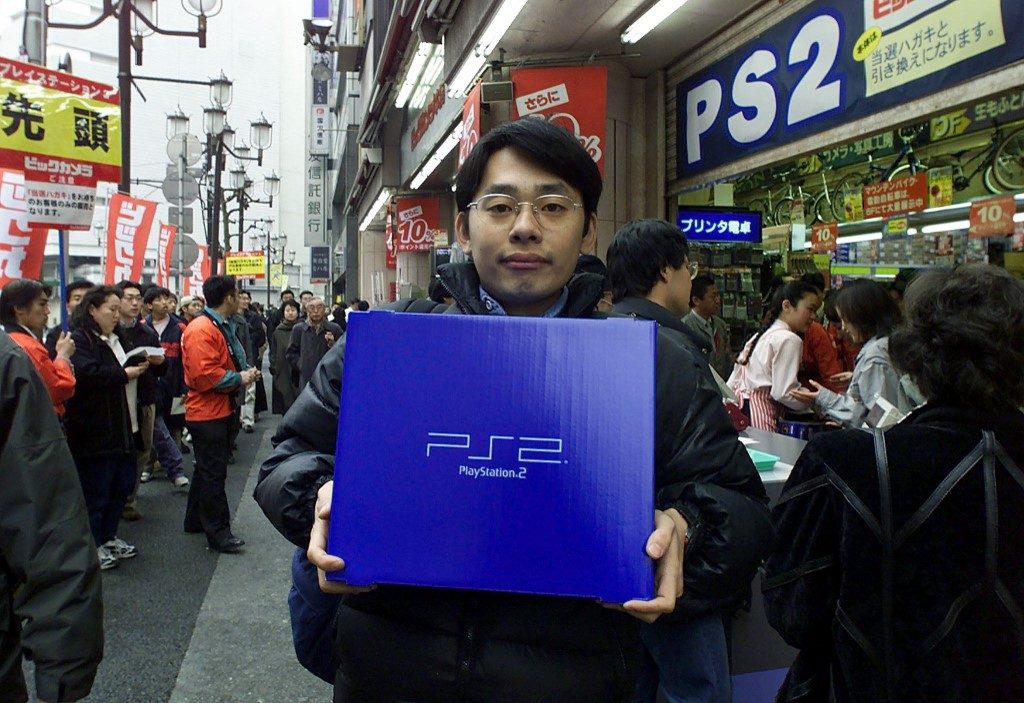 PS2. A student holds a package of Sony's PlayStation 2 after buying it at an electronic shop in Tokyo, on launch day, March 4, 2000. Photo by Toshifumi Kitamura/AFP 