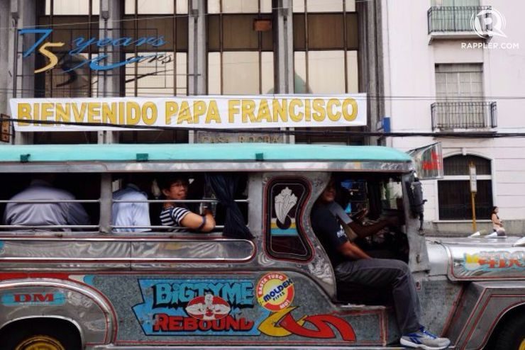 WELCOME, POPE FRANCIS. A jeep passes by one of the many welcoming signs and tarpaulins for Pope Francis in Intramuros, Manila. Photo by  Pat Nabong
