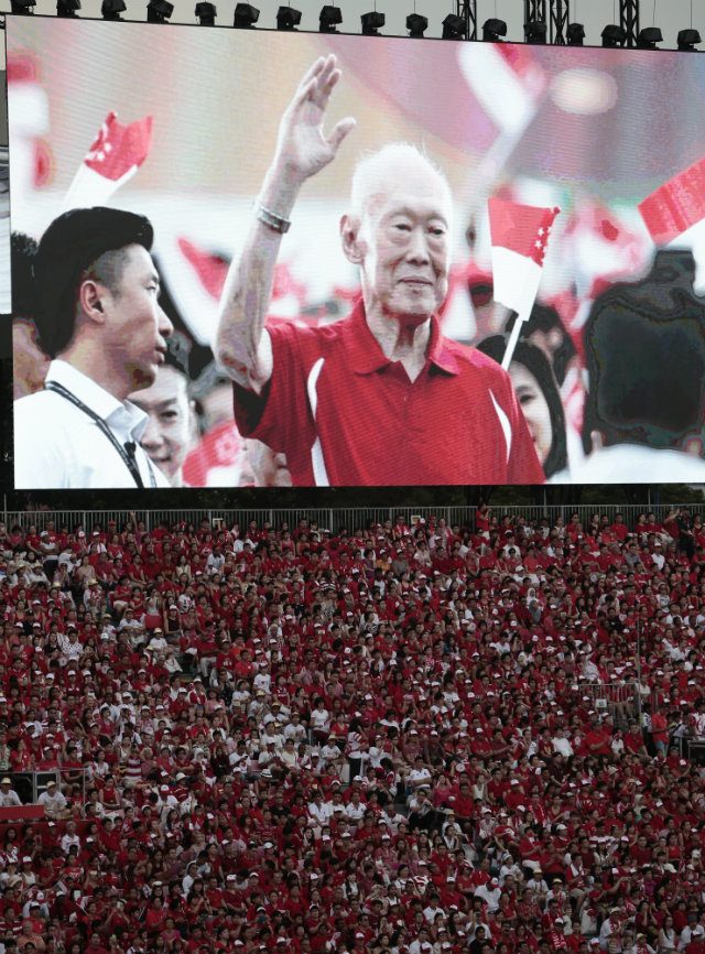 FIRST TIME. An image of Singapore’s late founding father Lee Kuan Yew is displayed on a electronic board above the crowd during the National Day Parade in Singapore, 09 August 2015. This is the first National Day after Lee’s death in March. Photo by Wallace Woon/EPA 