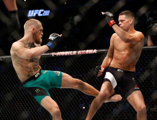 REMATCH. Conor Mcgregor lands a leg kick to Nate Diaz's right leg, a staple of McGregor's attack in the rematch. Photo by Steve Marcus/Getty Images/AFP 